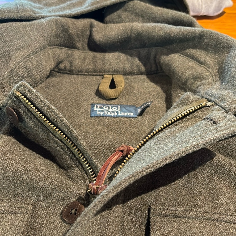 Wool three-quarter lengths men’s pea coat with detachable hood.